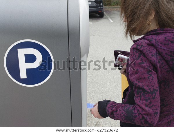 Woman pays for\
parking