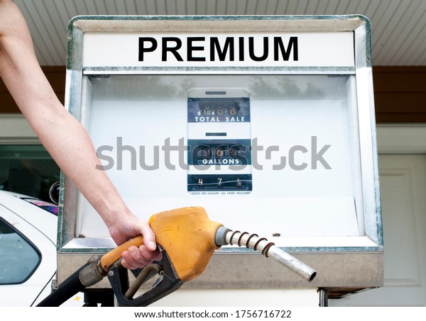 Woman pays for premium gasoline for her car at  a\
service station. 