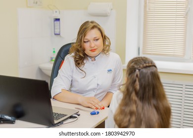 Woman Pediatric Neurologist Talking To A Girl In The Office.