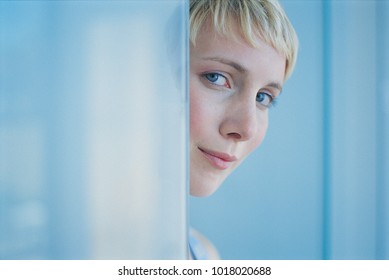 Woman Peeking Around Doorway