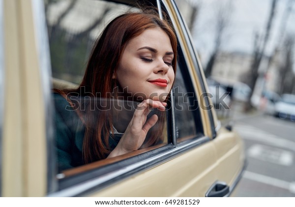 Woman peeking out the window in the car, a woman with\
red lipstick peeking out of the car window                         \
     