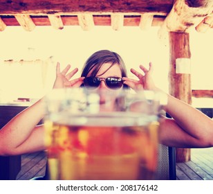 Woman Peeking Over A Fresh Draft Beer As Her Drink Toned With A Vintage Retro Style Instagram Filter