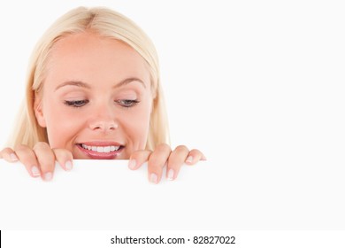 Woman Peeking Over A Whiteboard In A Studio