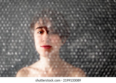 Woman Peeking Through Hole In The Texture