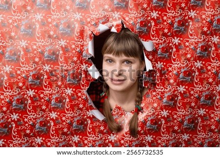 Similar – Image, Stock Photo Woman peeking through Christmas wrapping paper, festive mood