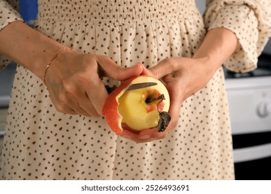 Woman peeling apple using knife cooking food dish on kitchen at home, hands close-up. Female housewife in dress preparing dish from apples. Culinary, cuisine, healthy eating, baking concept. - Powered by Shutterstock