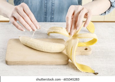 Woman peeling a banana