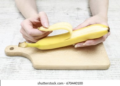 Woman Peeling A Banana