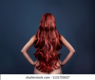 Woman With Perfect Curly Dyed Hairstyle From Behind. Fashion Portrait Of Red Head Woman From The Back Over Dark Background. Perfect Beatiful Long Red Hair.