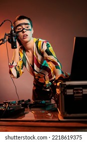 Woman Performer Producing Techno Music At Mixer, Having Crazy Make Up And Playing With Audio Stereo Equipment. Artist Mixing Sounds At Turntables To Make Musical Performance In Studio.