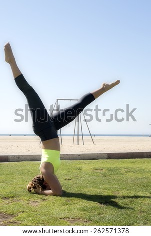 Woman performing a balancing headstand