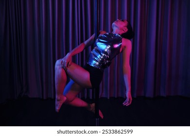 Woman Performing Pole Dance in Shiny Outfit - Powered by Shutterstock