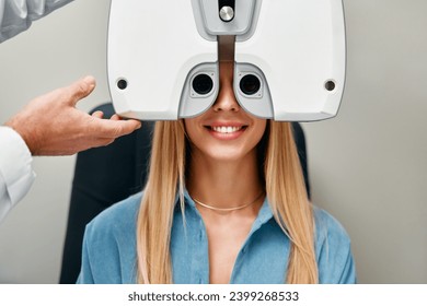 A woman performs an eye test with an optometrist in an optical store, An optometrist checks a woman's vision in a clinic. Ophthalmology and vision correction. - Powered by Shutterstock