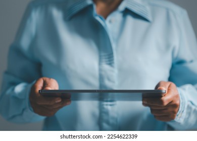 Woman person hands with digital tablet on dark for business or technology background. - Shutterstock ID 2254622339