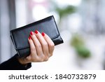 woman person holding a wallet in the hand. Cost control expenses shopping in concept. Leave space to write descriptive text.