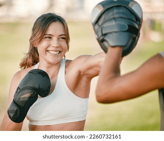 Woman, personal trainer and boxing exercise outdoor in nature park for fitness, health and wellness. Couple of friends happy about sports workout or mma training with motivation, energy and coaching - Powered by Shutterstock