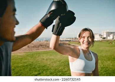 Woman, personal trainer and boxing high five for win, achievement or success outdoor in nature park. Couple of friends happy for sport workout or fight training with motivation, energy and man coach - Powered by Shutterstock