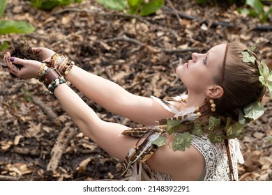 Woman Personifying An Earth Goddess In The Forest While Honoring Mother Nature