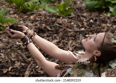 Woman Personifying An Earth Goddess In The Forest While Honoring Mother Nature