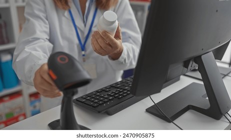 A woman pharmacist scans a medication bottle at the pharmacy counter indoors using a barcode scanner. - Powered by Shutterstock