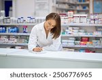 Woman, pharmacist and smile at counter with writing, prescription order and planning in pharmacy. Specialist, chemist and notepad with pen for medical information, report and inventory management