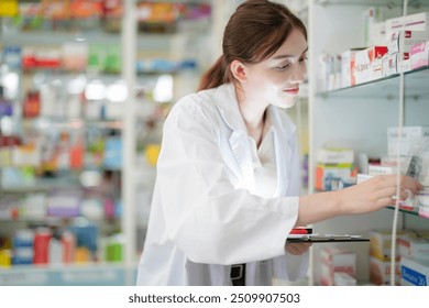 woman pharmacist wearing lab coat carefully selects medication in a pharmacy. critical role of pharmacists in ensuring patient safety and effective healthcare. female organizes medication on shelves. - Powered by Shutterstock