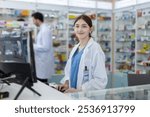 woman pharmacists at counter with drug shelf store chemical products background. she looking at camera. female drug seller medicine information assortment. Pharmacy customer service.