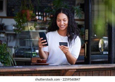 Woman, phone and credit card with smile for ecommerce, online shopping or purchase at coffee shop. Happy female customer on smartphone for internet banking, app or wireless transaction at cafe - Powered by Shutterstock