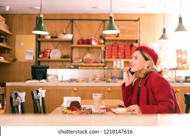 Woman With Phone. Elegant Beautiful Mature French Woman Holding Her Phone While Calling Her Friend