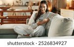 Woman, phone and typing on sofa in home with text message, social media post or online dating app. Girl, person and relax with smartphone on couch for mobile chat, communication and internet browsing