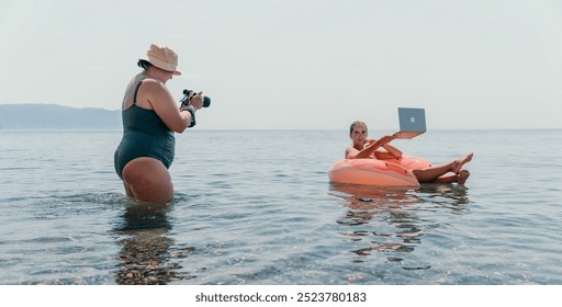 Woman Photographer Beach Vacation Pictures Taking photo of child on float in the ocean during vacation. - Powered by Shutterstock