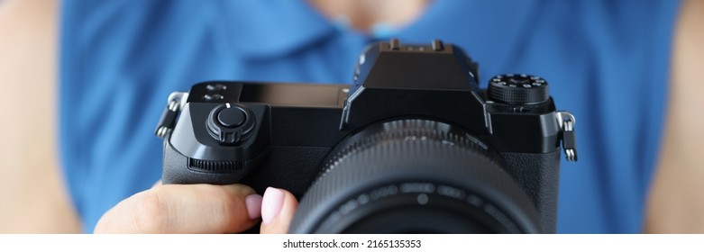 Woman Photographer In Blue Outfit With Camera In Her Hands In Photo Studio