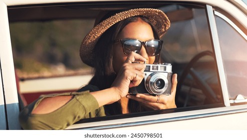 Woman, photographer and car with camera for road trip, sunset or memory on outdoor journey in nature. Female person with hat and sunglasses for capture, picture or sightseeing on adventure or tour - Powered by Shutterstock