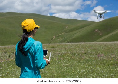 Woman Photographer Flying Drone Outdoors