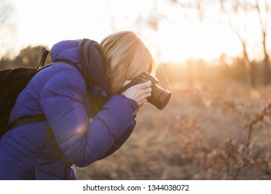 A Woman Photographer Holds A Camera In Her Hands. The Concept Of A Woman Photojournalist.