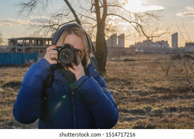 A Woman Photographer Holds A Camera In Her Hands. The Concept Of A Woman Photojournalist.