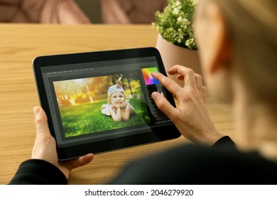 Woman Photographer Using Photo Editing App On Digital Tablet