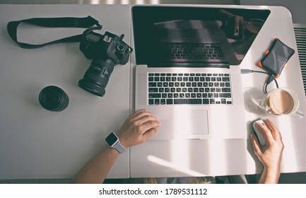 The woman photographer is working with laptop - Shutterstock ID 1789531112