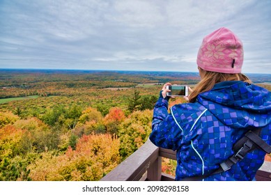 Woman Photographing Fall Tree Colors In The Midwest