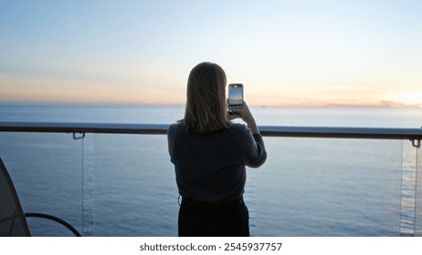 Woman photographing sunset on cruise ship deck, with calm ocean views and vibrant sky, capturing serene travel moment outdoors, reflecting tranquility and wanderlust. - Powered by Shutterstock