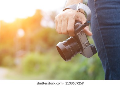 Woman phtographer hand holding digital camera for take photo
