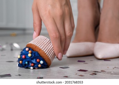 Woman Picking Up Dropped Cupcake From Floor, Closeup. Troubles Happen