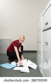 Woman Picking Up Dropped Paper