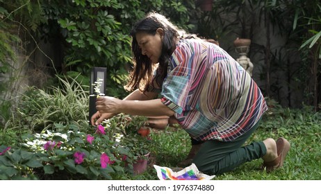 Woman Picking Herbs From Her Garden Orchard