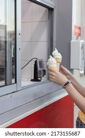 Woman Picking Up Ice Cream At The Order Pickup Window. High Quality Photo