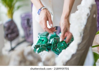 A Woman Is Picking Up A Malachite Crystal.