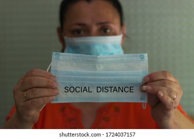 Woman Picking Up A Mask For Social Distance