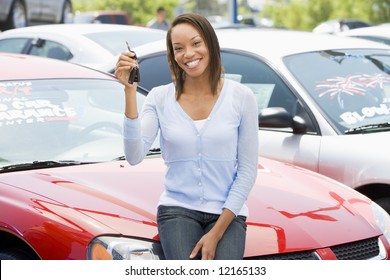 Woman picking up new car from lot