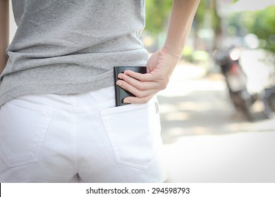 woman picking up phone from pocket