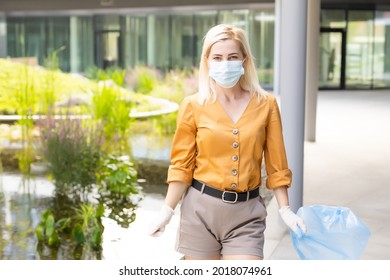 Woman Picking Up Plastic Household Waste In Park